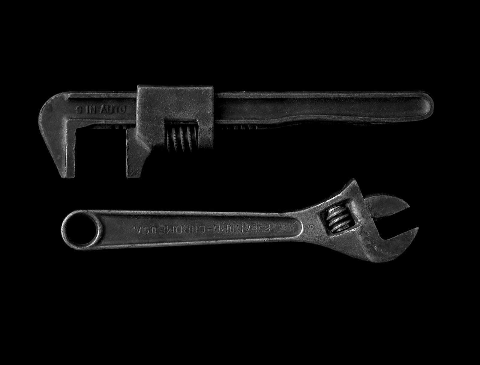 A pair of well-worn pipe wrenches